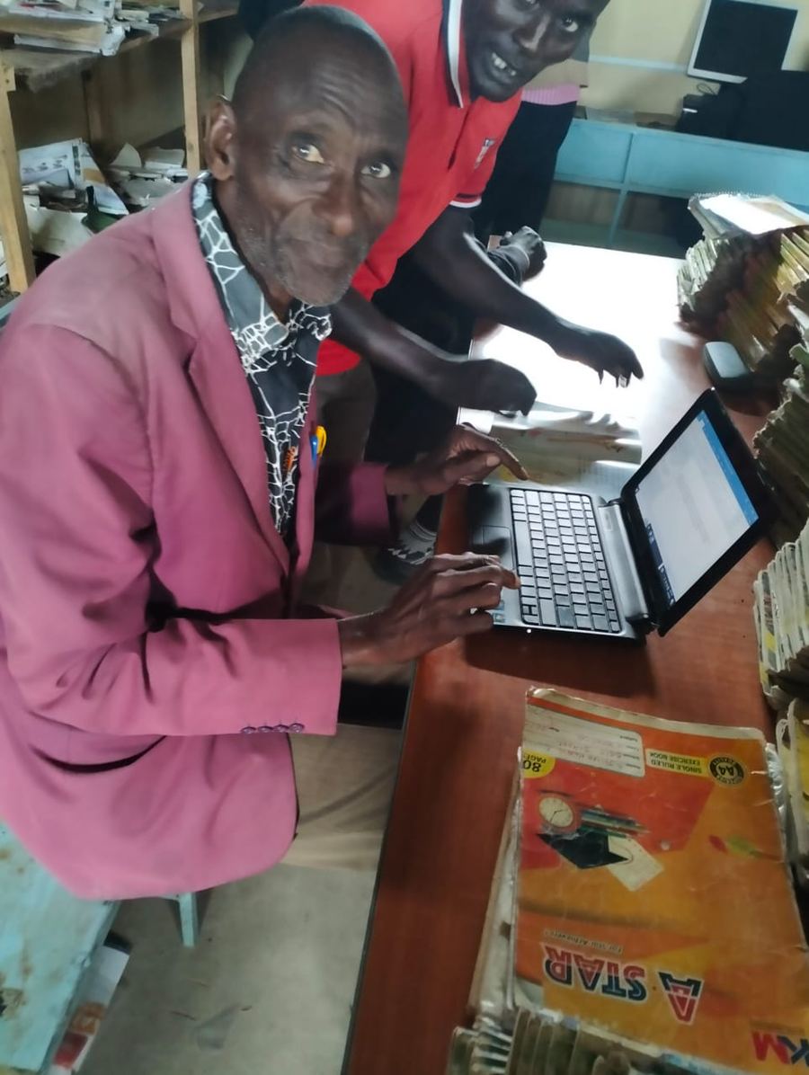 A seminary student seated at a desk writing an examination paper