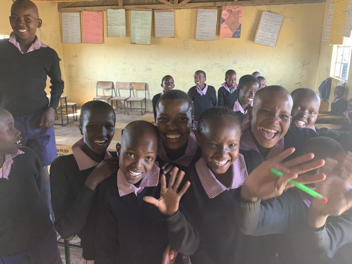 Students crowding round the camera in a classroom at the school in Empukani