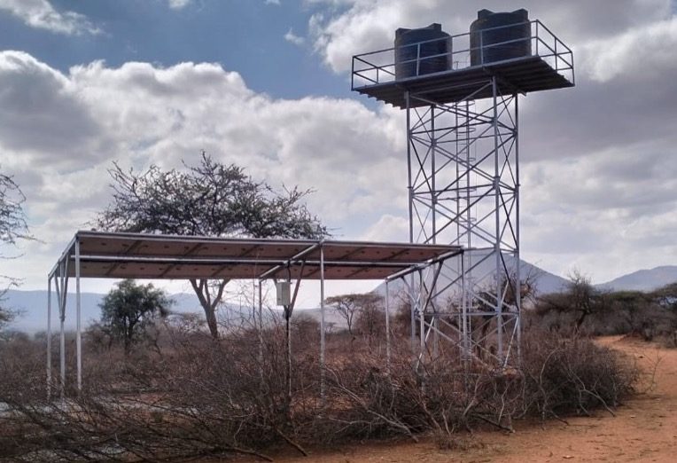 The solar array and 24-foot water tower at Hope Shamba Farm